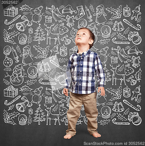 Image of Little Boy Looking For Christmas Gifts
