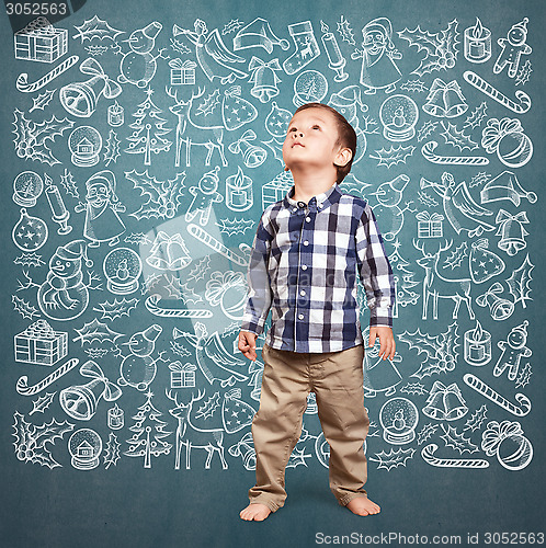 Image of Little Boy Looking For Christmas Gifts