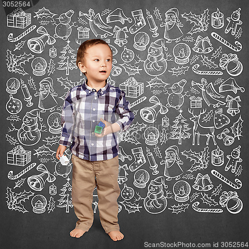 Image of Little Boy Looking For Christmas Gifts