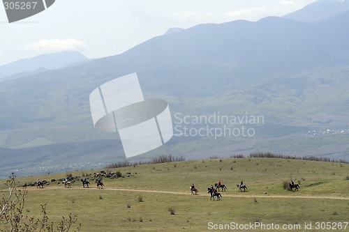 Image of The group of horsemen in mountains