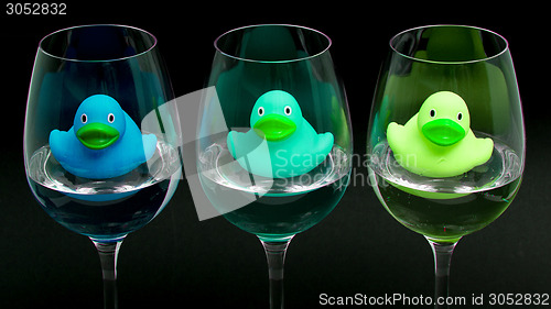 Image of Blue and green rubber ducks in wineglasses