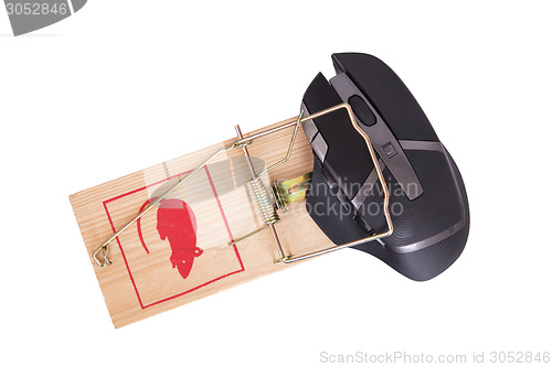 Image of Modern computer mouse in a mousetrap