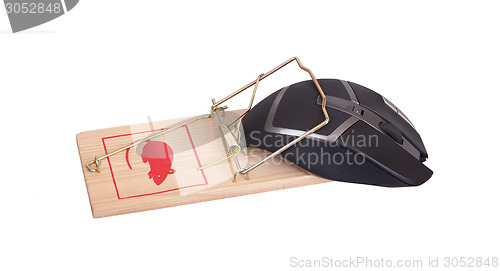 Image of Modern computer mouse in a mousetrap