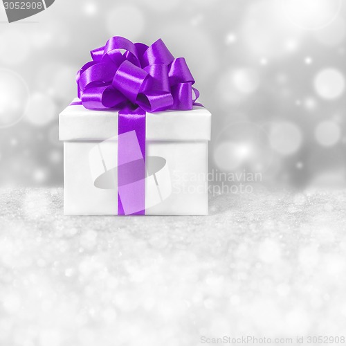 Image of gift box with purple ribbon bow