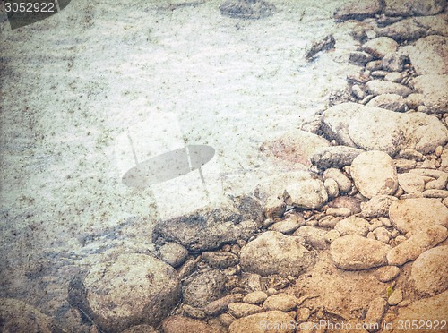 Image of old grungy water background, stones in a sea