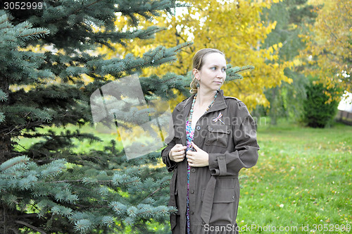 Image of Portrait of the beautiful woman against autumn leaves.