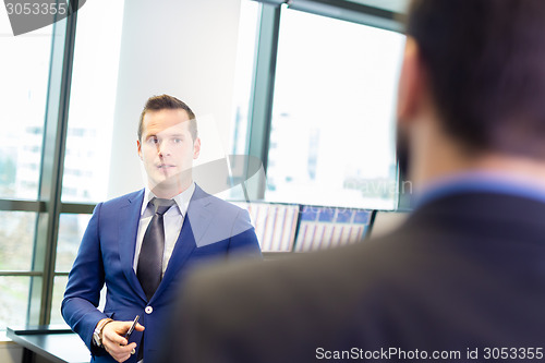 Image of Businessmen in modern office.