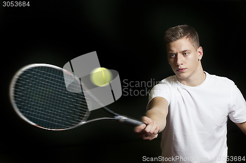 Image of Young man playing tennis