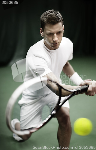 Image of Young man playing tennis