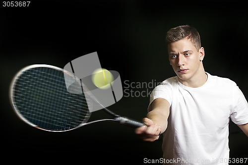 Image of Young man playing tennis