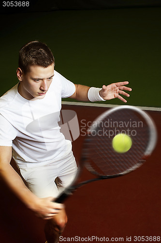 Image of Young man playing tennis