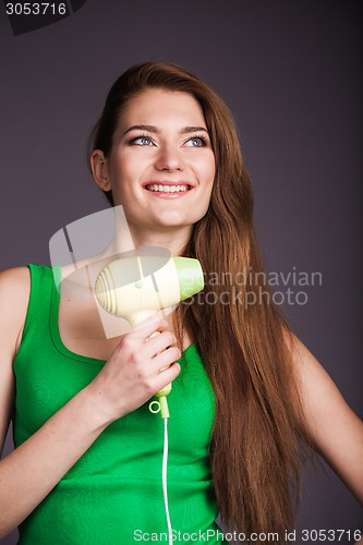 Image of Woman with hair dryer