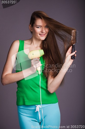 Image of Woman with hair dryer