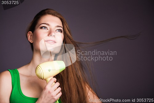 Image of Woman with hair dryer