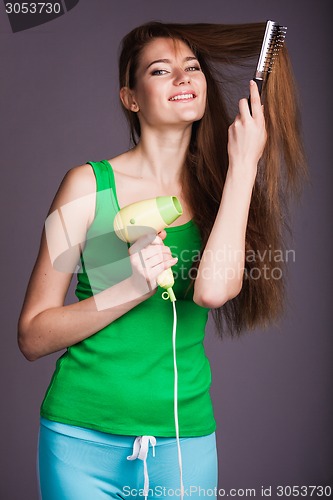 Image of Woman with hair dryer