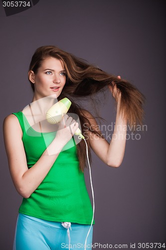 Image of Woman with hair dryer