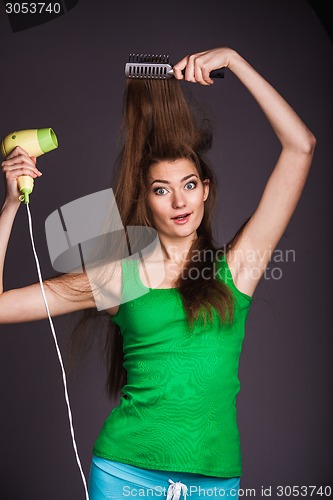 Image of Woman with hair dryer