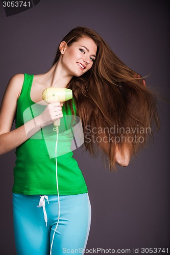 Image of Woman with hair dryer