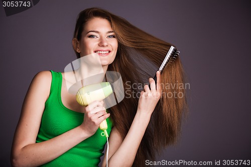 Image of Woman with hair dryer