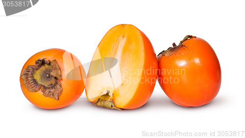 Image of Two Whole And One Half Persimmons