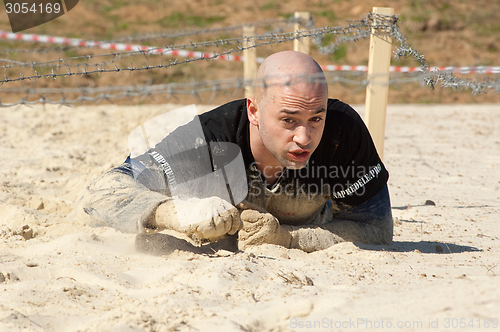 Image of Man crawling on sand