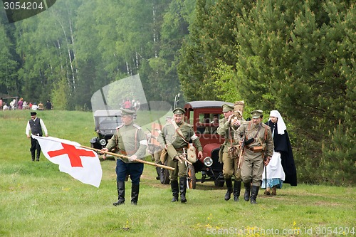 Image of Unidentified men with medicine red cross flag