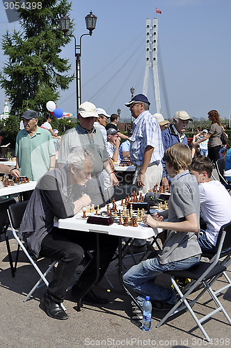 Image of Chess tournament on the street in the summer.