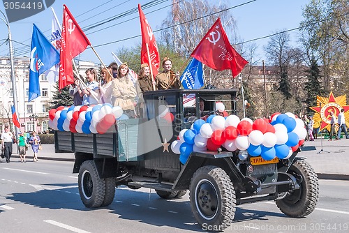 Image of Truck with girls in uniform of times WW2 on parade