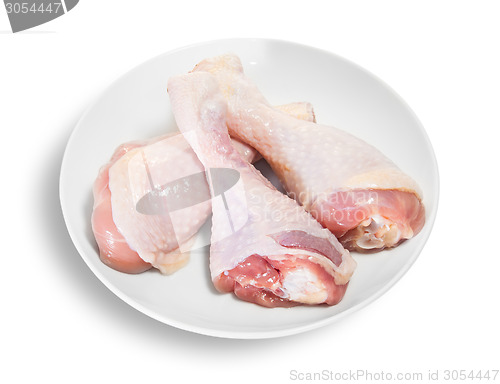 Image of Three Raw Chicken Legs On White Plate