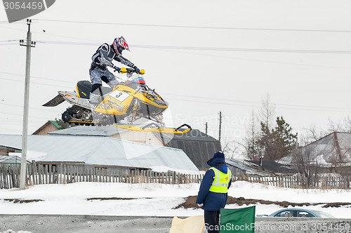 Image of Jump of sportsman on snowmobile