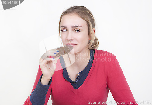 Image of young woman enjoying chocolate