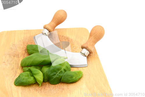 Image of Fresh basil leaves with a rocking knife