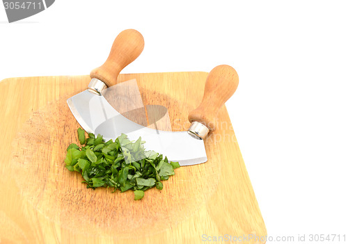 Image of Chopped fresh basil leaves with a rocking knife