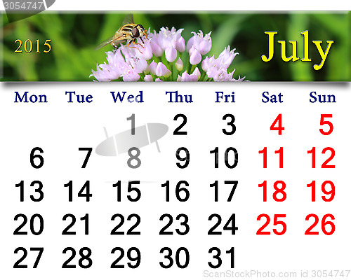 Image of calendar for July of 2015 with fly on the flower