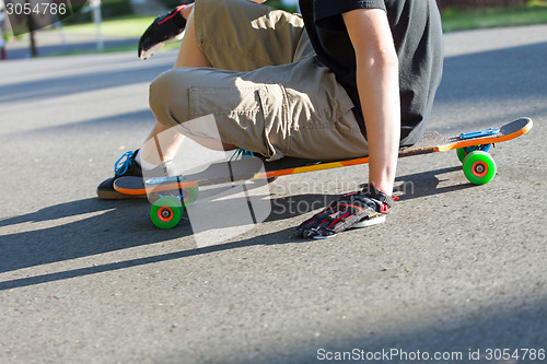 Image of Longboarder Sitting