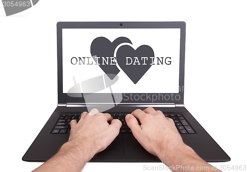 Image of Man working on laptop, online dating