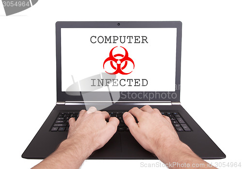 Image of Man working on laptop, computer infected