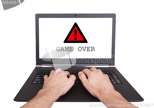 Image of Man working on laptop, game over