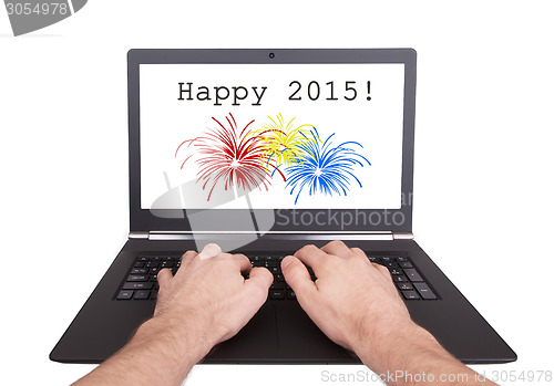 Image of Man working on laptop, happy 2015