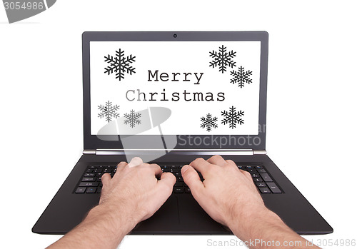 Image of Man working on laptop, merry christmas