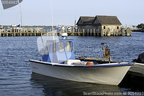Image of fishing boat in bay harbor marina Montauk New York USA the Hampt