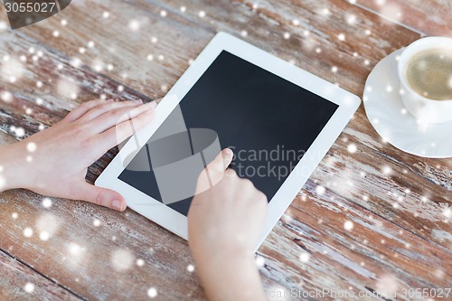 Image of hands pointing finger to blank tablet pc screen