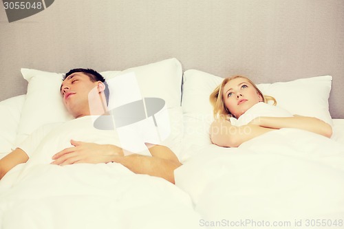 Image of happy couple sleeping in bed