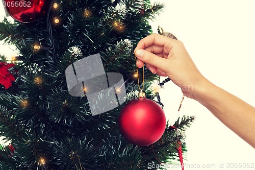 Image of close up of woman with christmas tree decoration