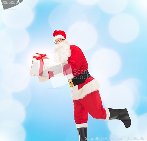 Image of man in costume of santa claus with gift box