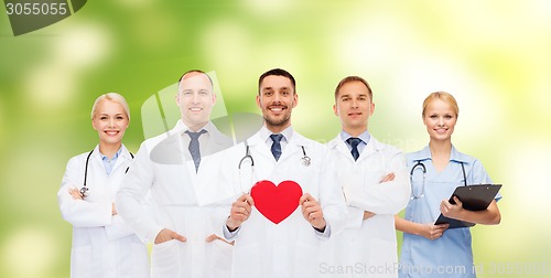 Image of group of smiling doctors with red heart shape