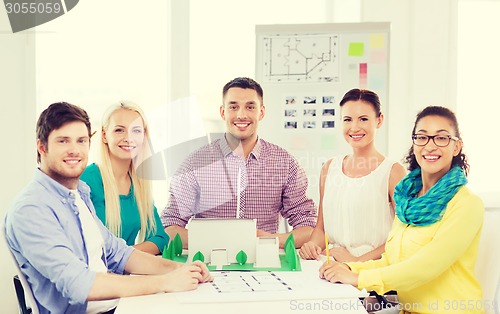 Image of smiling architects working in office