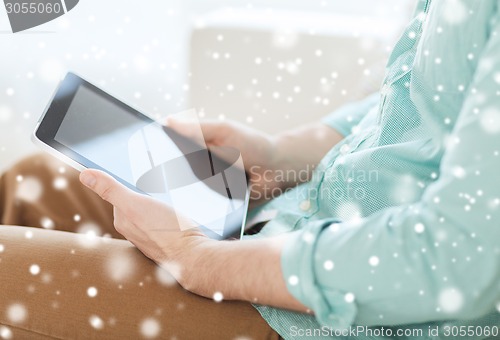 Image of close up of man with tablet pc computer at home