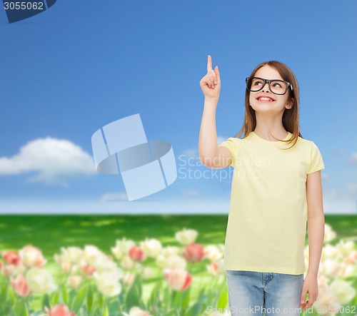 Image of smiling cute little girl in black eyeglasses