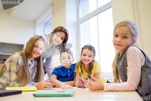 Image of group of school kids writing test in classroom